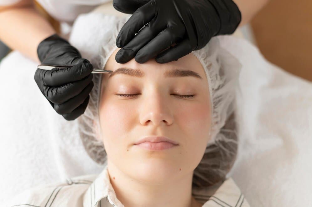 1768595259 young woman getting eyebrow treatment beauty salon 23 2148879545 1